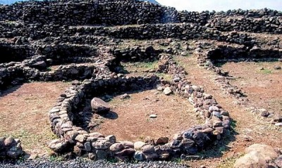 Ruinas de casas prehistóricas junto a la muralla que rodea el pueblo de la Edad de Bronce (1400-1200 ac).