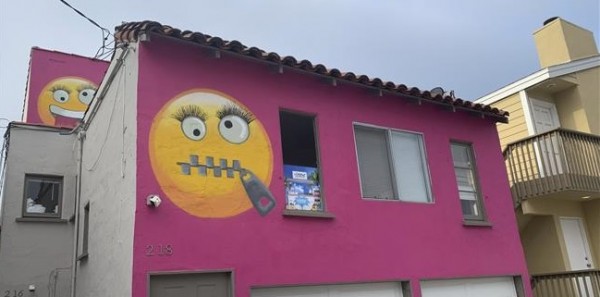 Denunciata dai suoi vicini, li ridicolizza dipingendo la facciata di casa di rosa