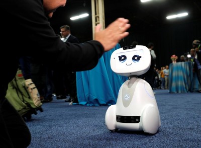 Buddy, an entertainment and assistant robot by Blue Frog Robotics, interacts with a attendee during CES Unveiled at the 2018 CES in Las Vegas, Nevada, U.S. January 7, 2018